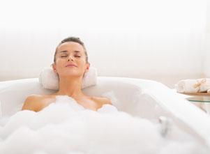 Photo of a woman relaxing in a bath, the importance of taking time for yourself after having a baby